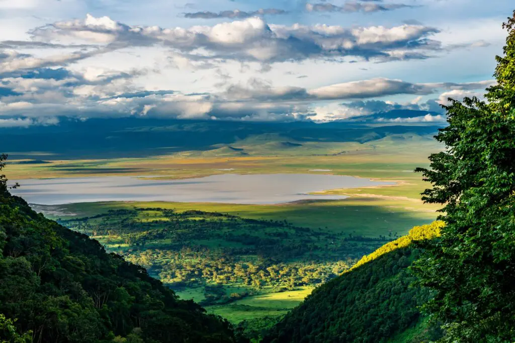 elevated view of Ngorongoro Crater floor with lake and dramatic clouds